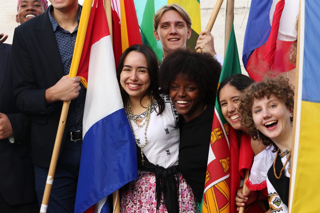 Group of students with flags smiling