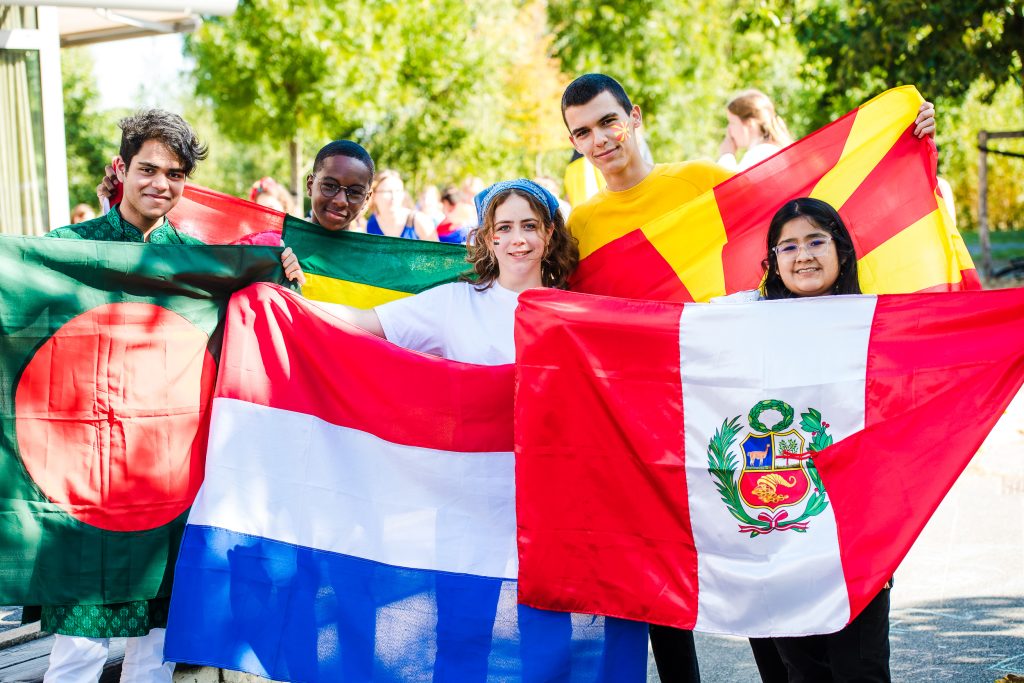 Students celebrating proudly with their national flags