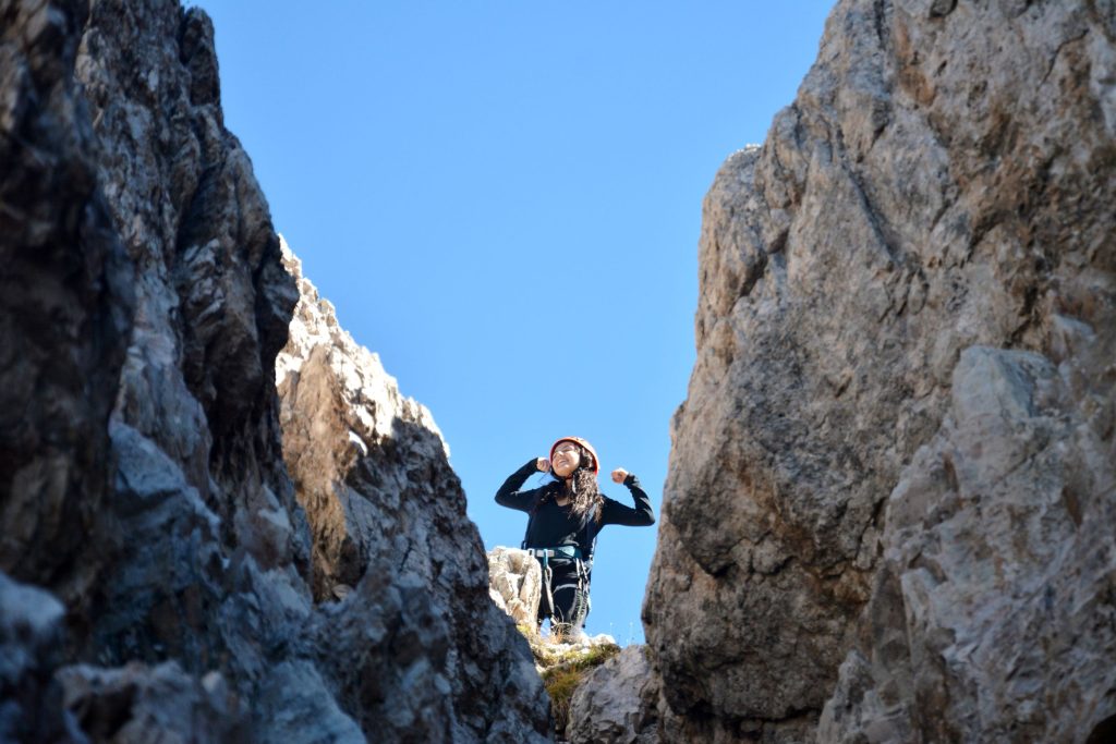 Student summiting a mountain.